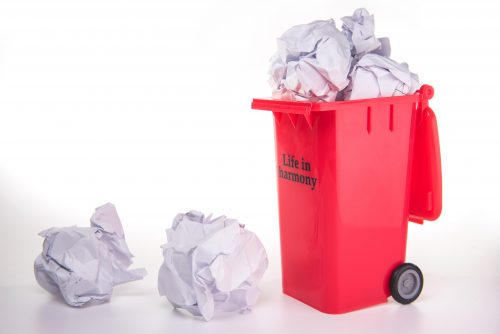 red garbage figure with crumpled paper ball